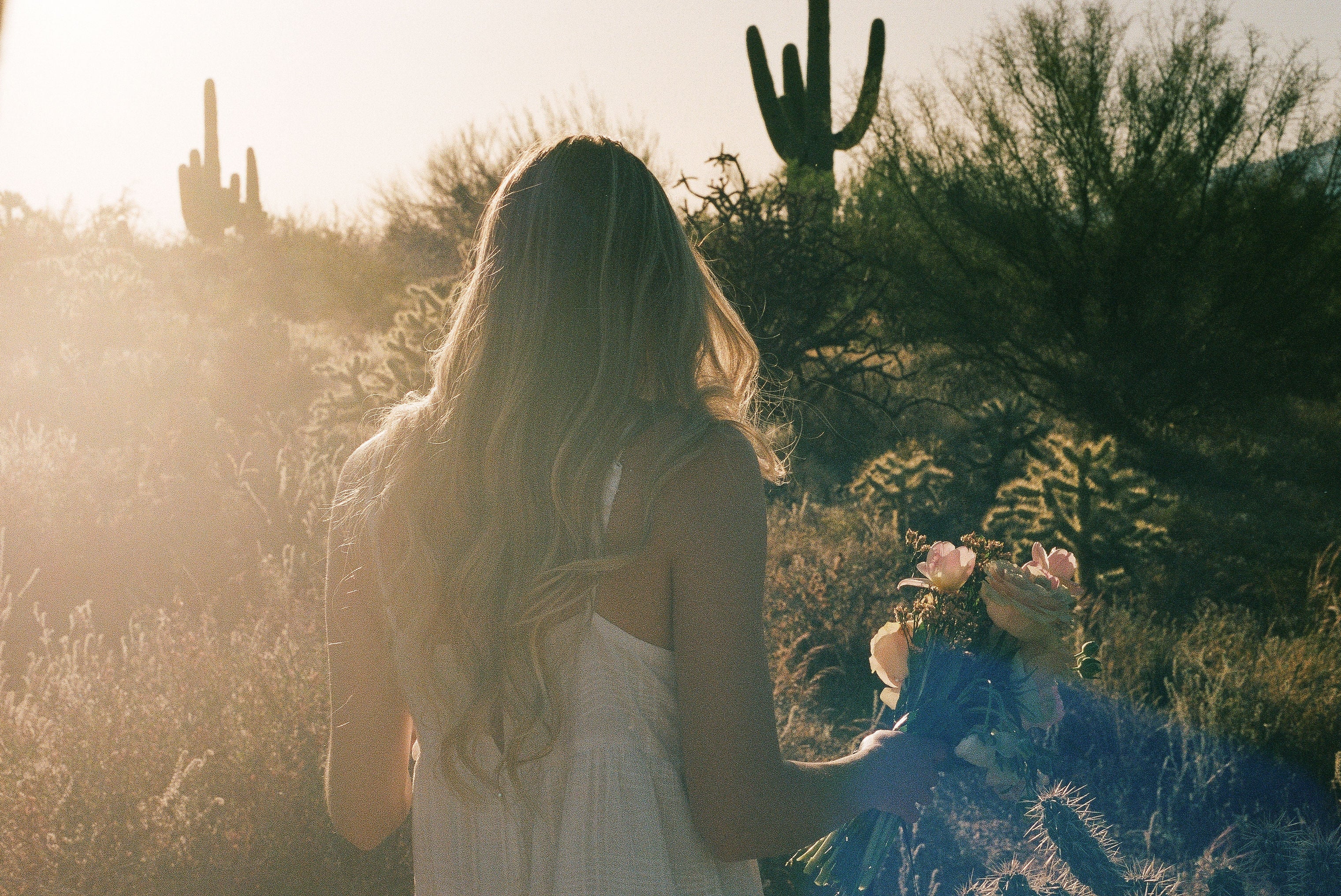 Woman in the desert holding flowers