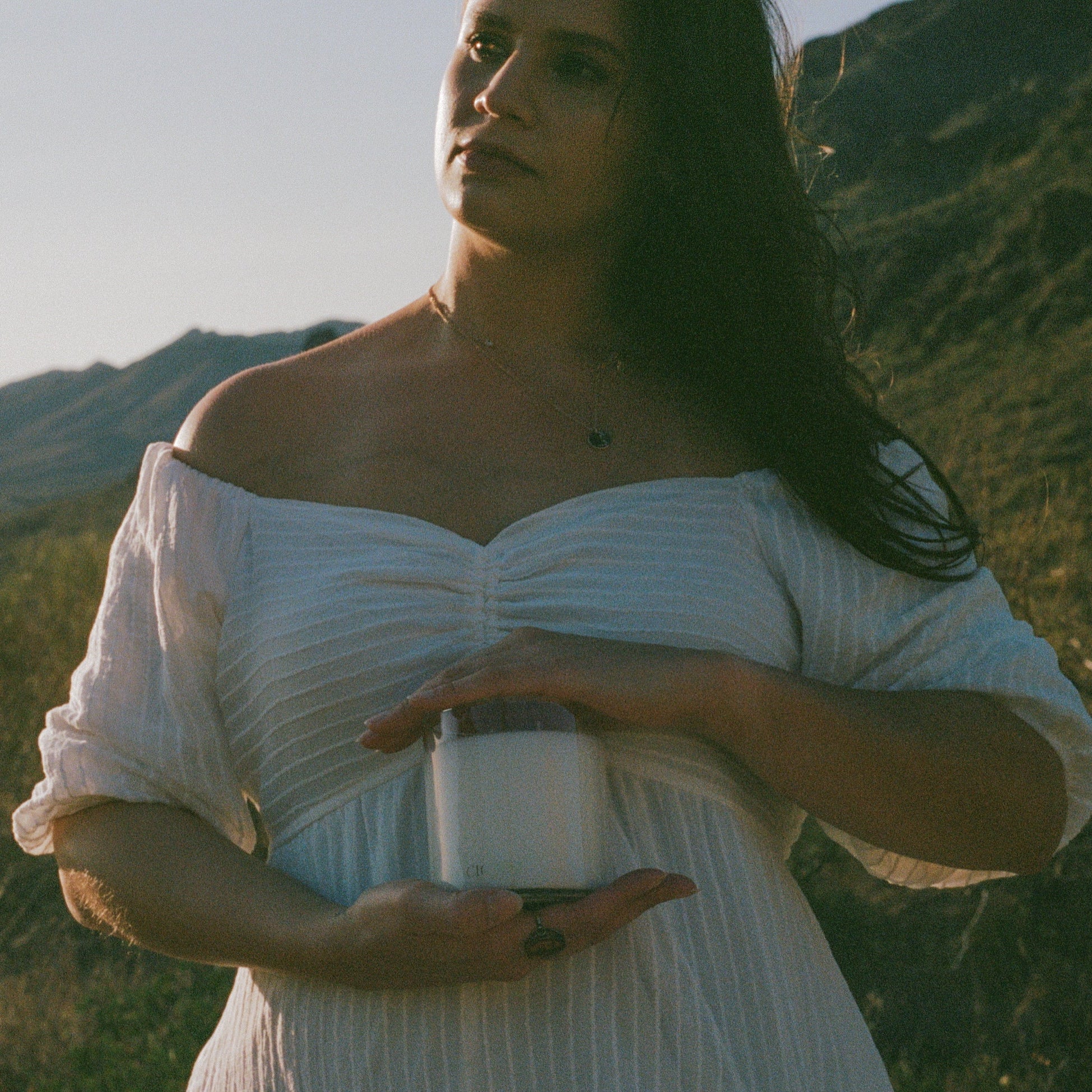 Woman holding candle in the desert.