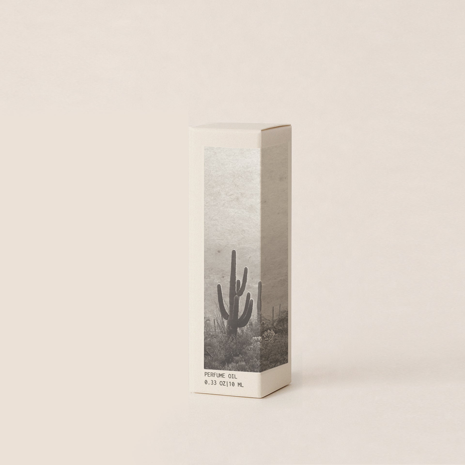 A tall rectangular perfume oil box with a minimalist desert cactus illustration in grayscale, standing upright on a warm off-white background.